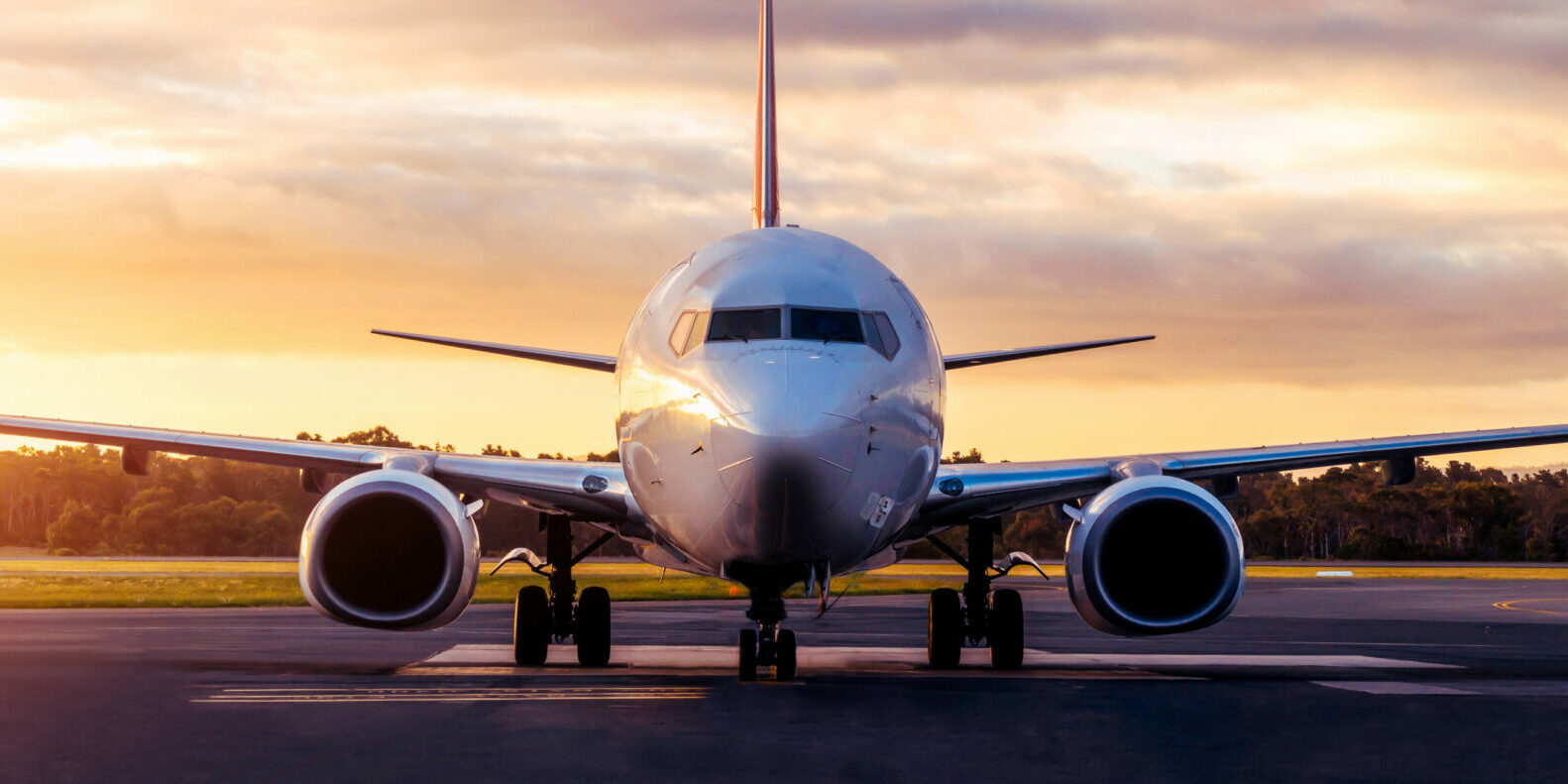 Sunset view of airplane on airport runway under dramatic sky in Hobart,Tasmania, Australia. Aviation technology and world travel concept.